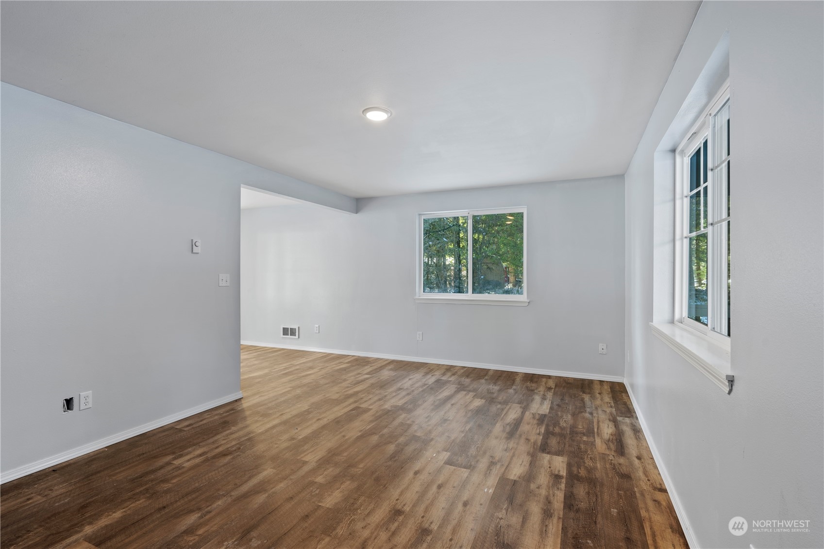 8323 Cedar Grove Avenue Concrete, WA 98237 - Photo 4 of 37 an empty room with wooden floor and windows