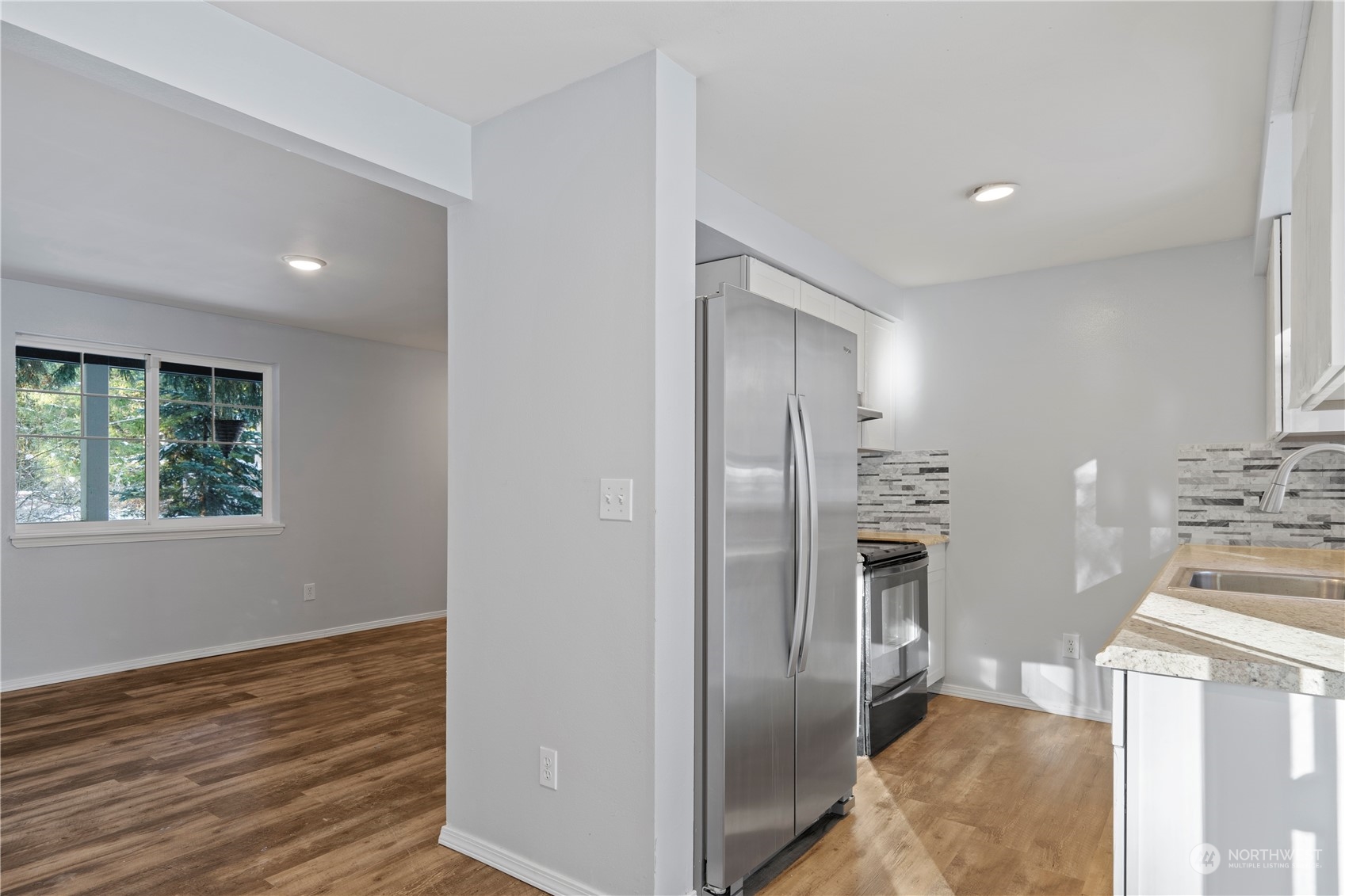8323 Cedar Grove Avenue Concrete, WA 98237 - Photo 10 of 37 a view of a kitchen with refrigerator and wooden floor