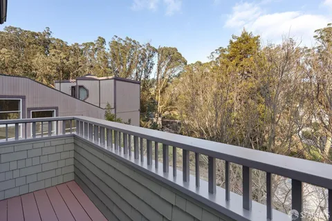 a bathroom with a granite countertop sink a mirror a glass door and shower