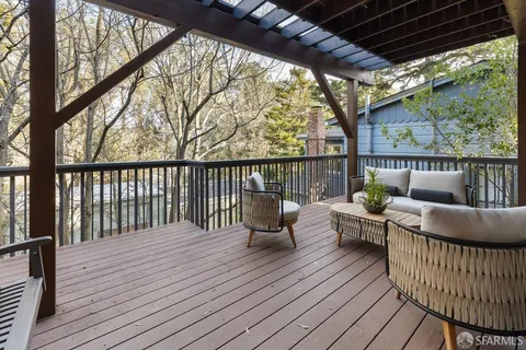 a view of a house with a wooden deck