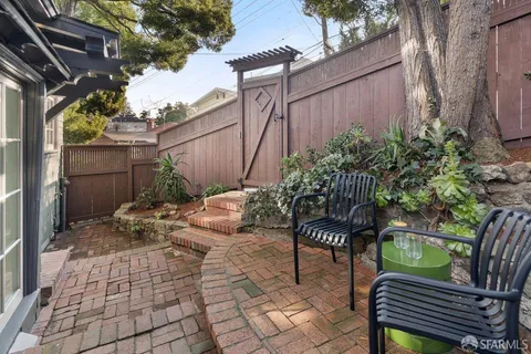 a backyard of a house with table and chairs