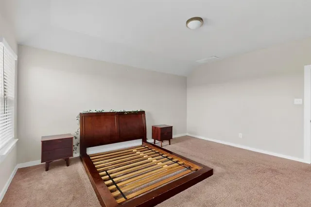 a bedroom with bunk bed and a window