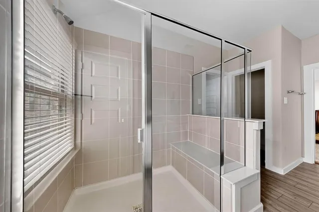 a bathroom with a glass shower door