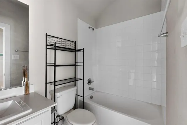 a bathroom with a shower a toilet and a sink