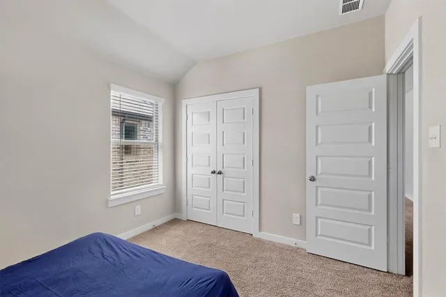 an empty room with windows and closet