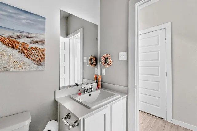 a bathroom with a sink a toilet and mirror
