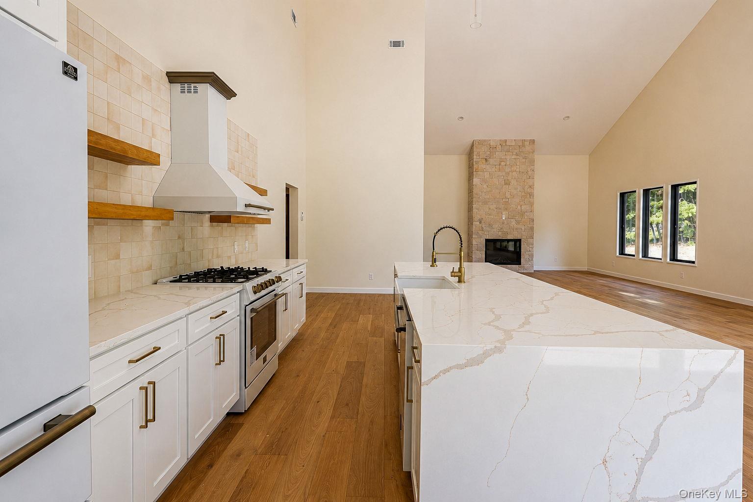 128 St Elmo Road Wallkill, NY 12589 - Photo 12 of 45 Open-concept kitchen featuring luxury Forno appliances, an expansive island with an integrated sink and brass faucet