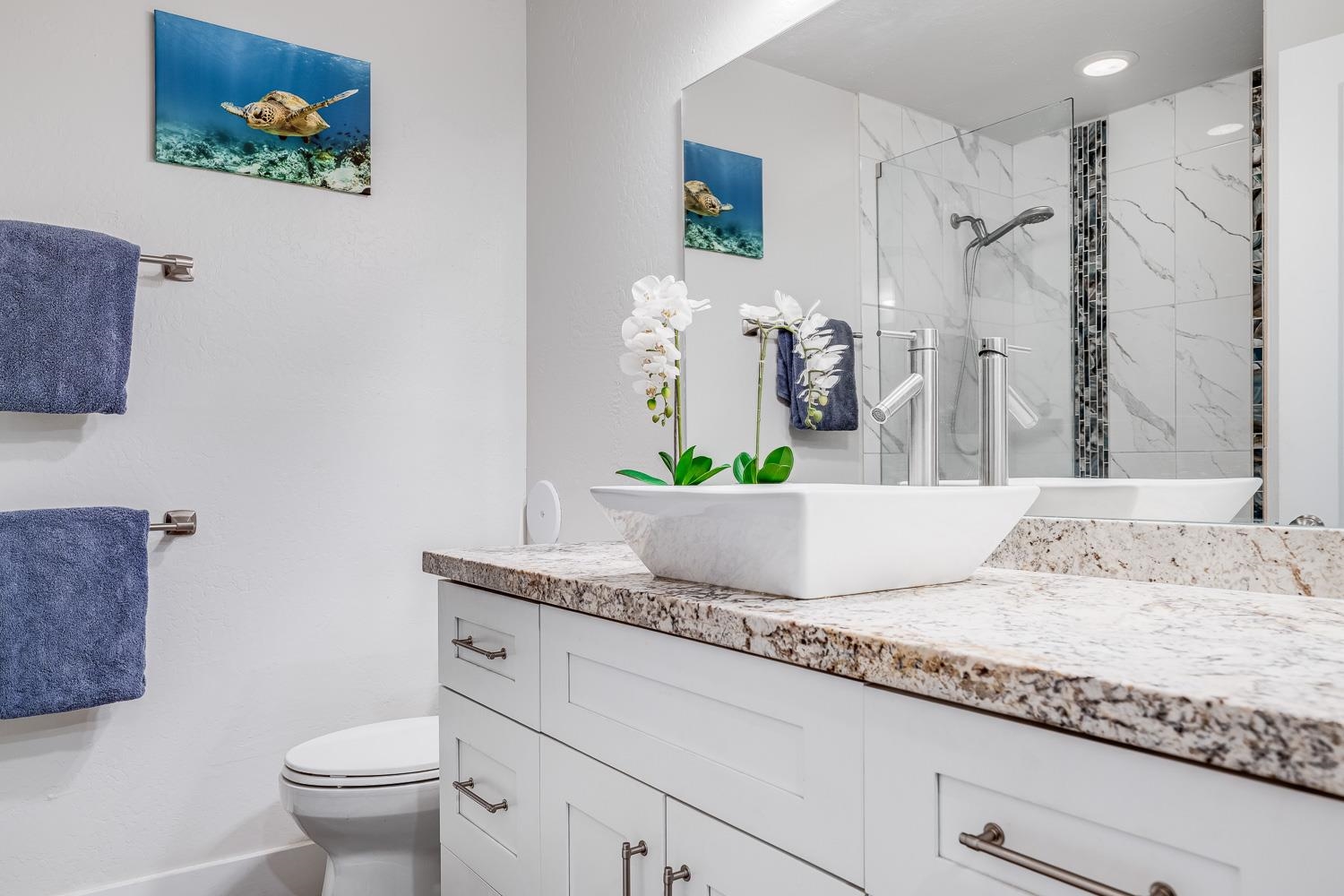2737 South Kihei Road, Unit 142 Kihei, HI 96753 - Photo 3 of 43 a bathroom with a granite countertop sink a toilet and a mirror