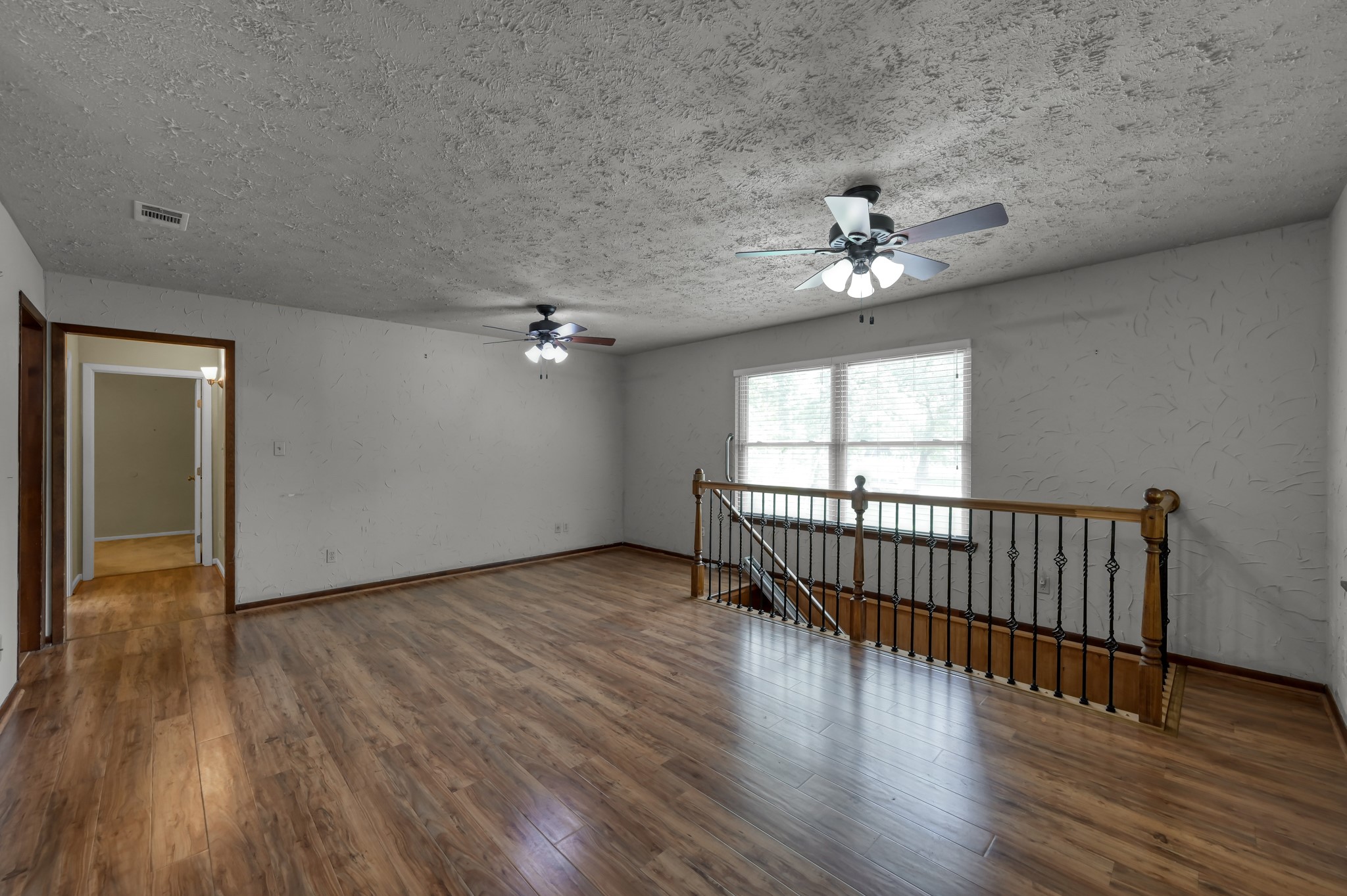 2207 Arendale Lane Spring, TX 77386 - Photo 7 of 30 Living space within the upstairs garage apartment showing stairs with chairlift from downstairs entry door.