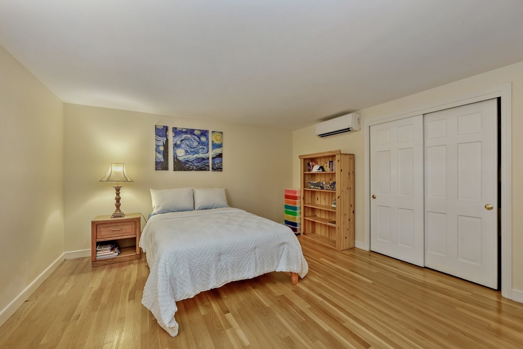 9 Tower Drive Dover, MA 02030 - Photo 15 of 26 a bedroom with a bed and a wooden floor