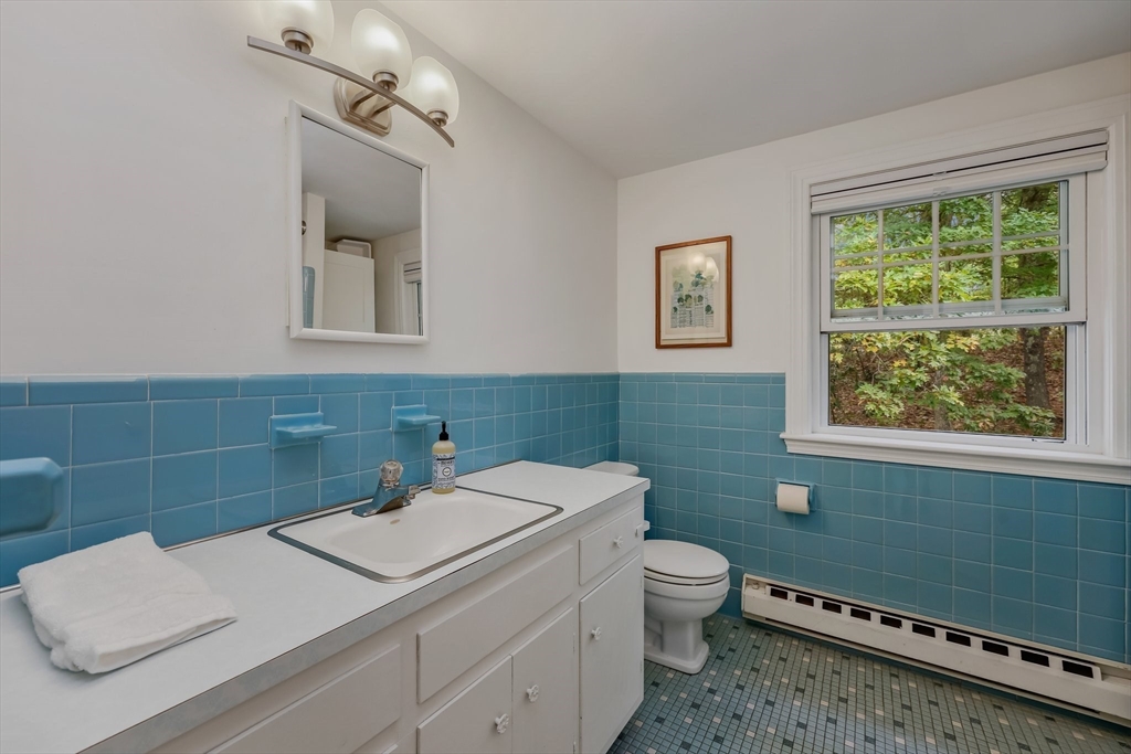 9 Tower Drive Dover, MA 02030 - Photo 18 of 26 a bathroom with a toilet sink and mirror