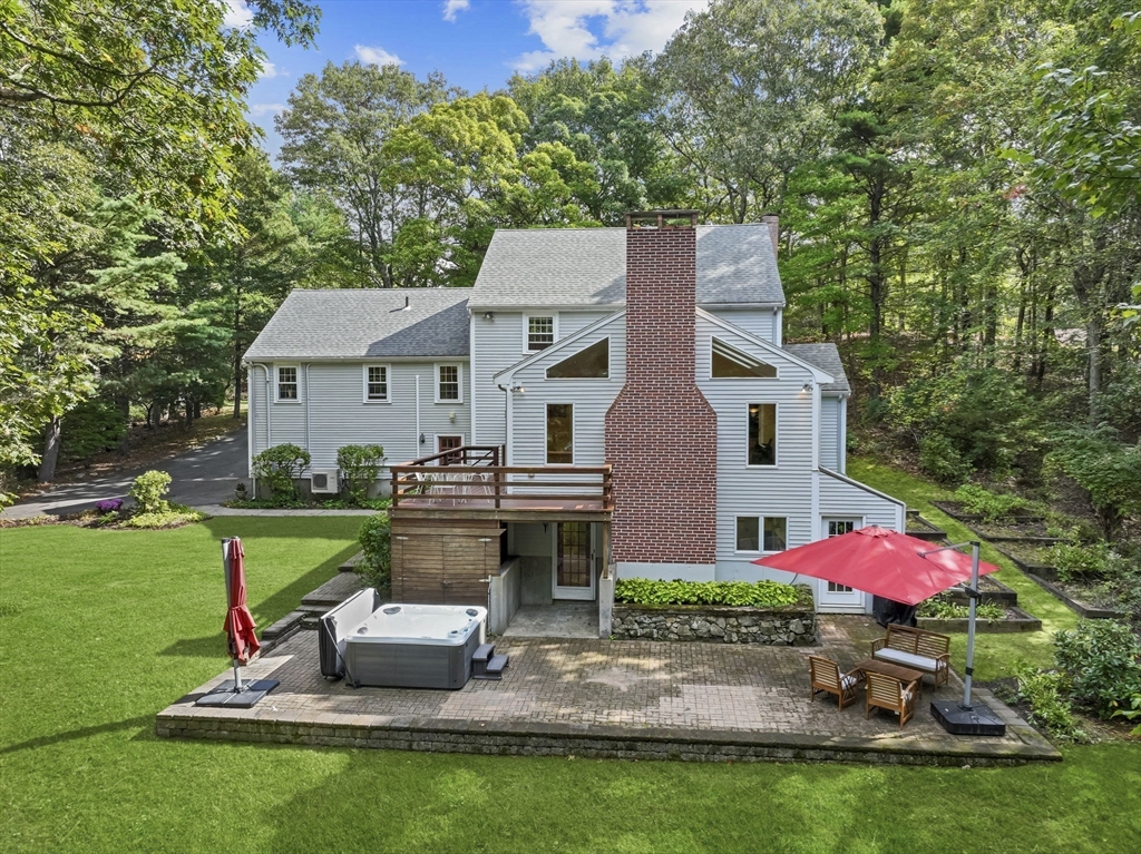 9 Tower Drive Dover, MA 02030 - Photo 2 of 26 a view of a house with backyard sitting area and garden