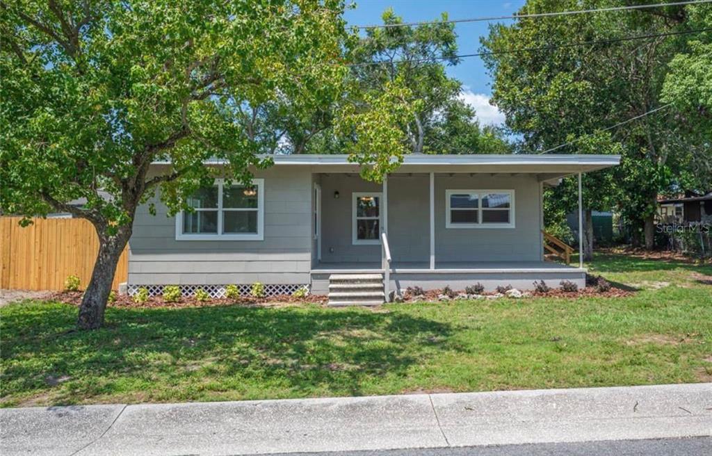 1065 North 10th Street Eagle Lake, FL 33839 - Photo 1 of 16 a front view of house with yard