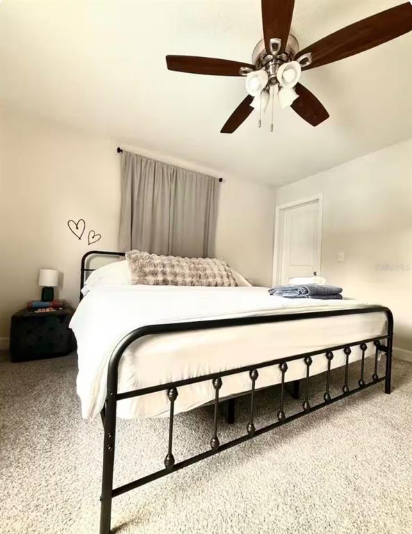 1065 North 10th Street Eagle Lake, FL 33839 - Photo 6 of 16 a bedroom with a bed a ceiling fan and a dresser