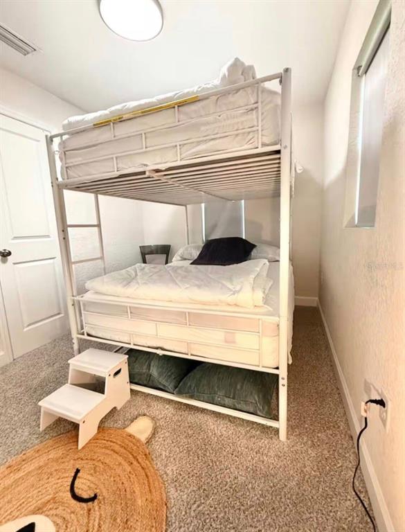 1065 North 10th Street Eagle Lake, FL 33839 - Photo 8 of 16 a bedroom with a bed and a table