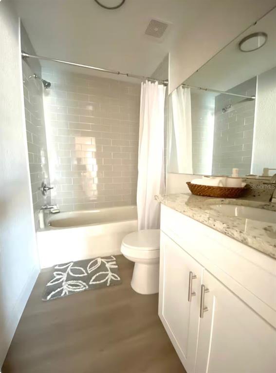 1065 North 10th Street Eagle Lake, FL 33839 - Photo 9 of 16 a bathroom with a granite countertop sink toilet and shower