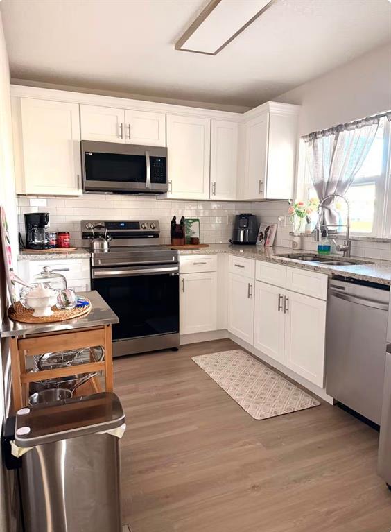 1065 North 10th Street Eagle Lake, FL 33839 - Photo 10 of 16 a kitchen with a stove and a microwave