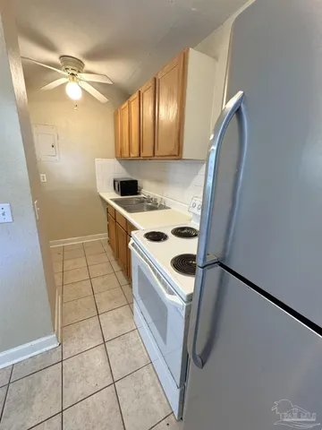 a view of a kitchen with cabinets and wooden floor