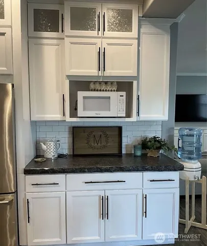 a white toilet sitting in a bathroom next to a window