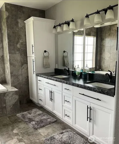 a living room with furniture rug and wooden floor