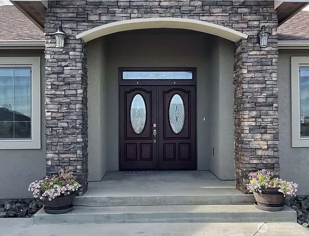 a kitchen with granite countertop white cabinets and white appliances