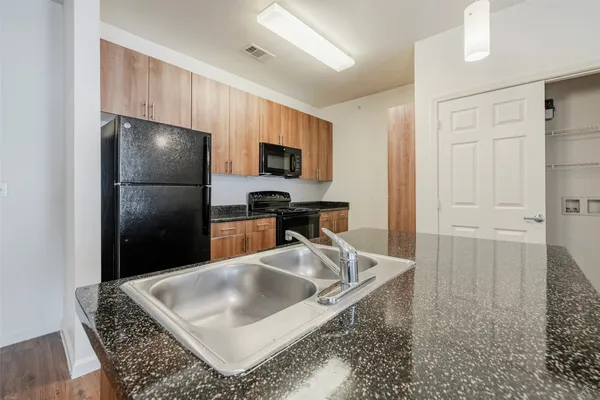 a kitchen with kitchen island a counter top space cabinets and a refrigerator