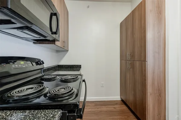 a stove top oven sitting inside of a kitchen