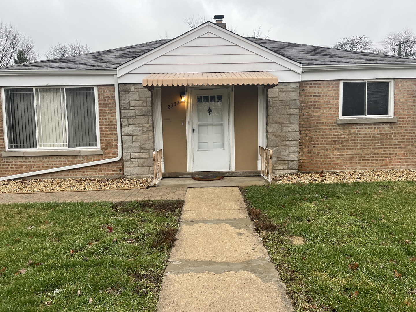 2337 175th Street Homewood, IL 60430 - Photo 1 of 12 a front view of a house with a yard