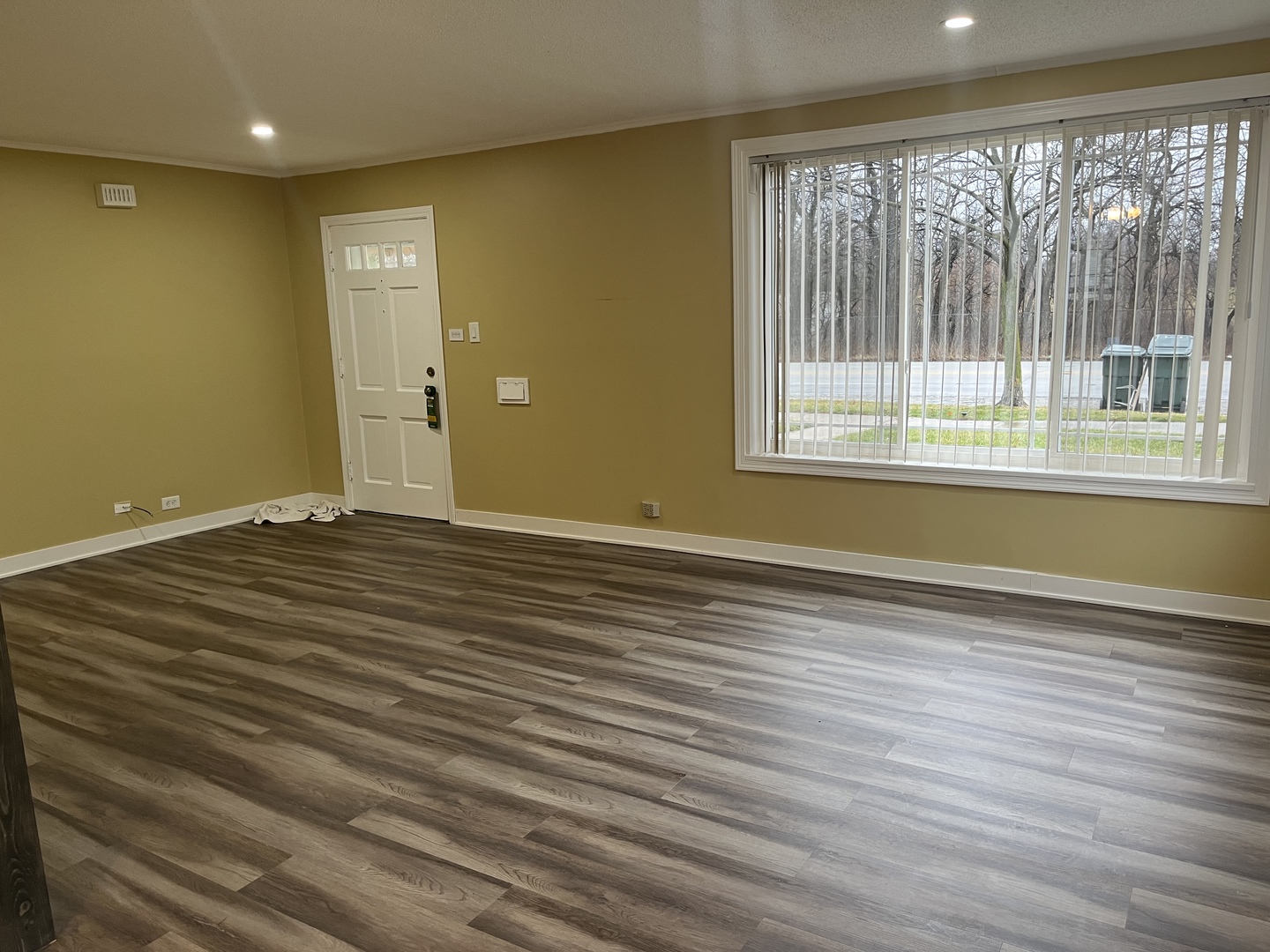 2337 175th Street Homewood, IL 60430 - Photo 3 of 12 a view of an empty room with wooden floor and a window