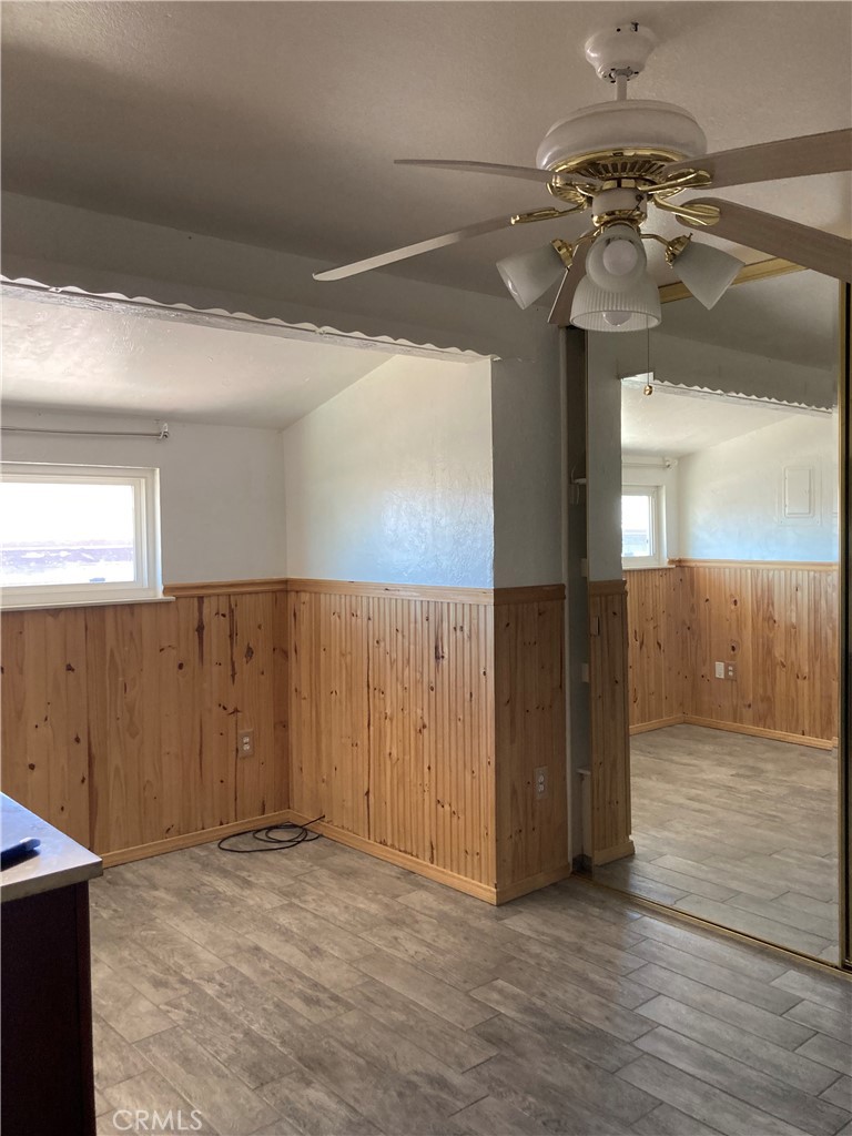 1201 Elizabeth Street Barstow, CA 92311 - Photo 16 of 19 a view of a room with a mirror and a ceiling fan
