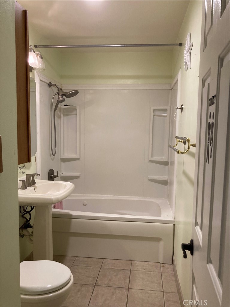 1201 Elizabeth Street Barstow, CA 92311 - Photo 17 of 19 a bathroom with a sink a toilet and shower