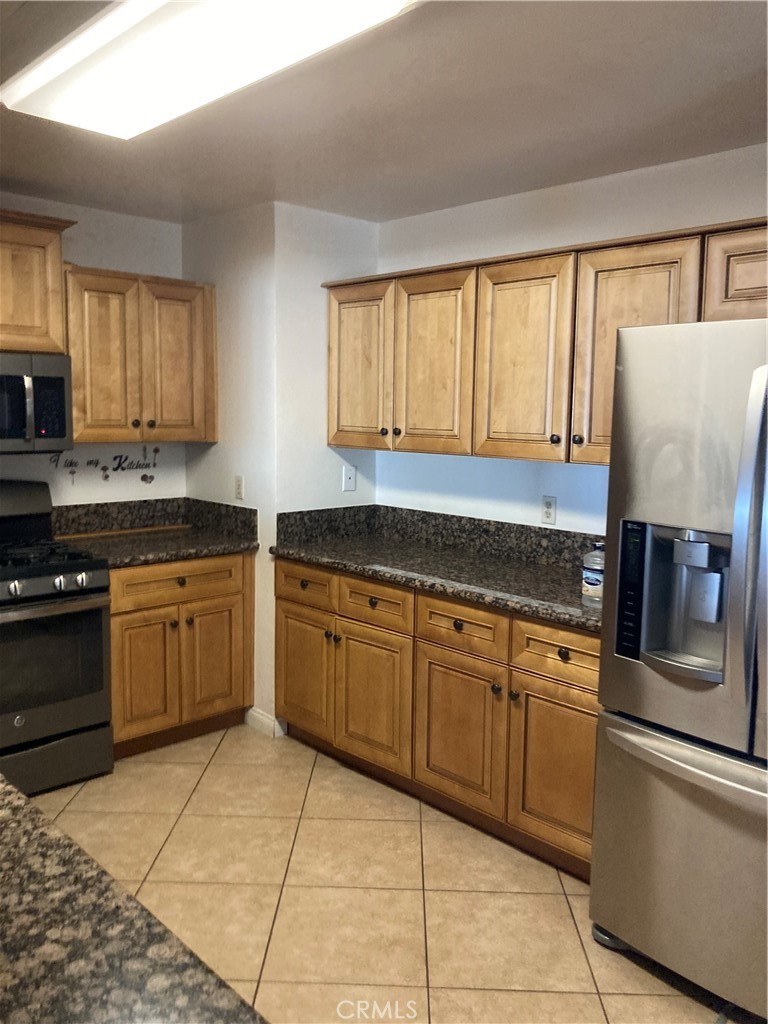 1201 Elizabeth Street Barstow, CA 92311 - Photo 9 of 19 a kitchen with a stove sink and cabinets