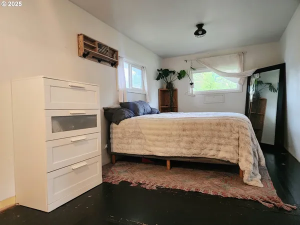 a bedroom with a bed and a dresser