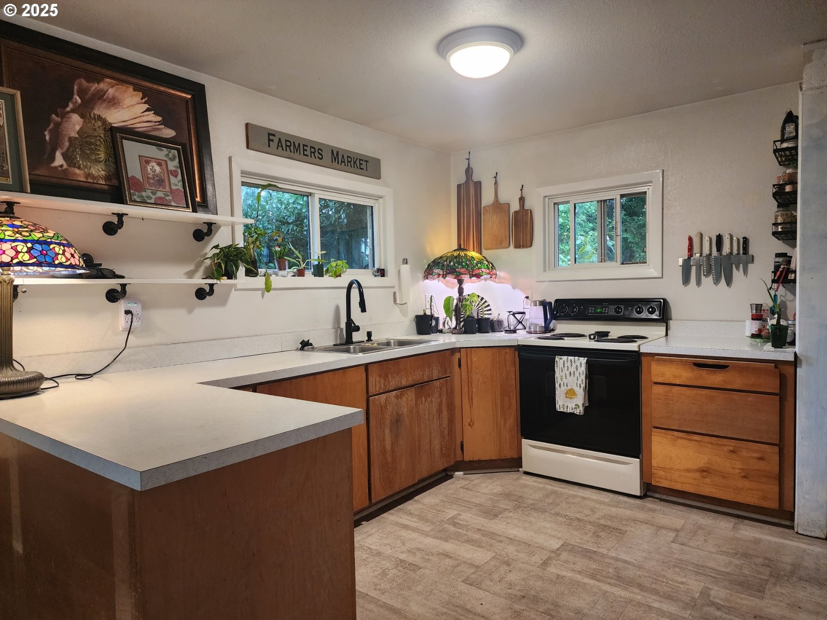 2605 Port Orford Loop Road Port Orford, OR 97465 - Photo 6 of 25 a kitchen with stainless steel appliances granite countertop a stove a sink and a microwave