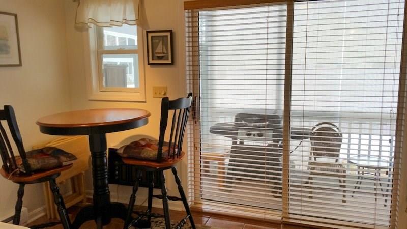 1762 Post Road, Unit 127 Wells, ME 04090 - Photo 8 of 19 Dining Area and Slider to Screened Porch