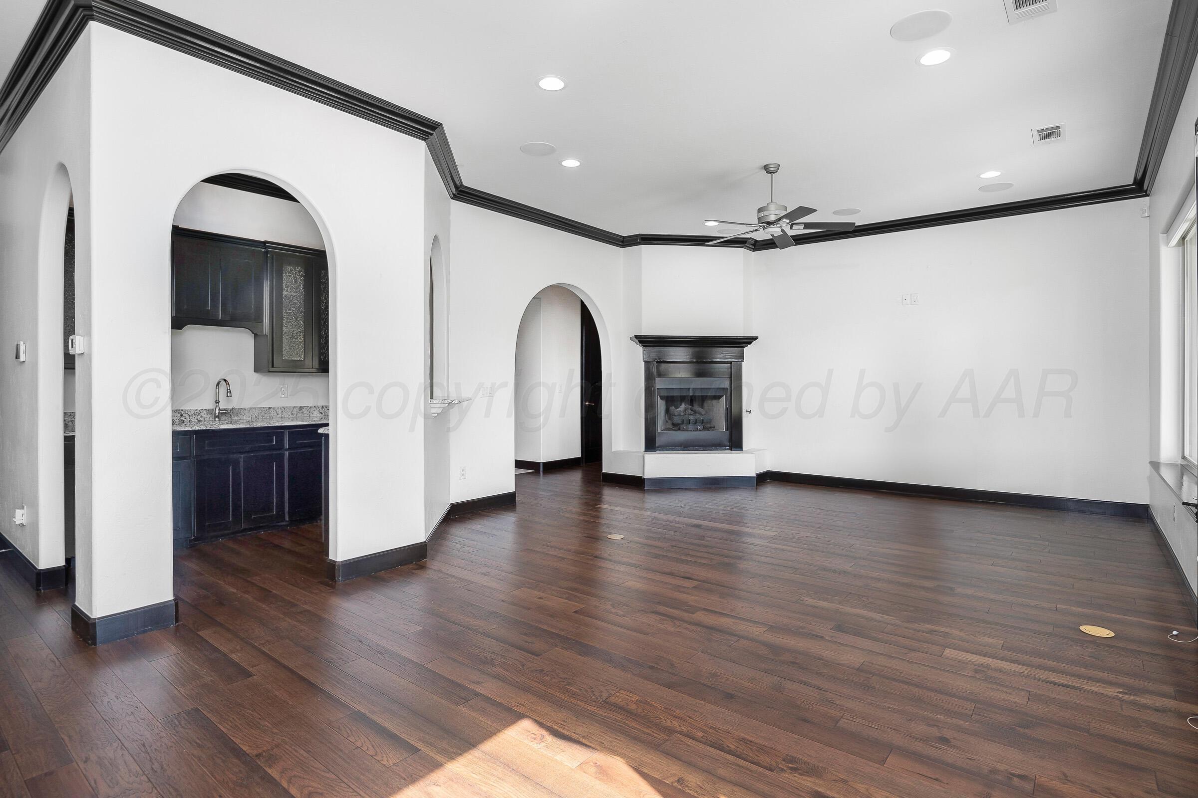 6 Merion Place Amarillo, TX 79124 - Photo 12 of 46 a view of empty room with wooden floor and kitchen