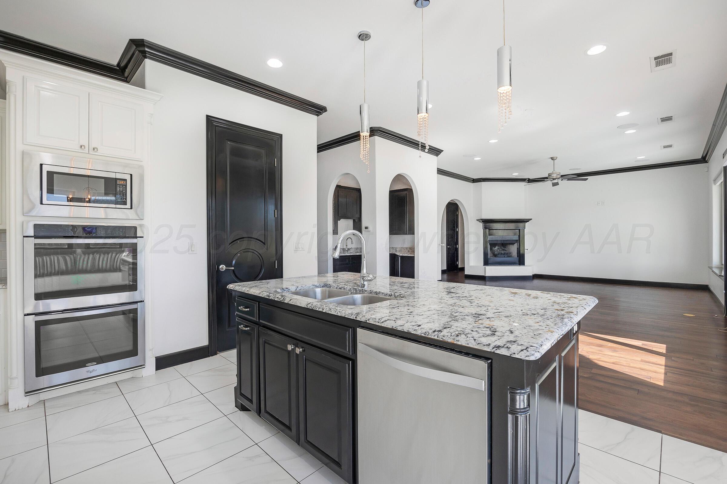 6 Merion Place Amarillo, TX 79124 - Photo 18 of 46 a kitchen with stainless steel appliances granite countertop a sink and a refrigerator