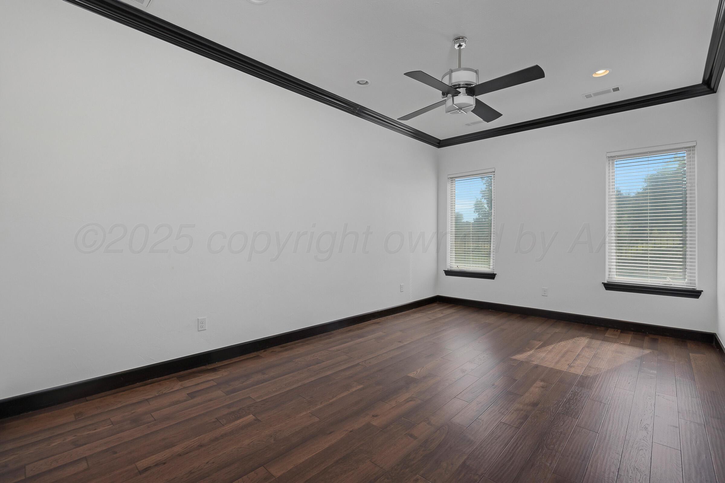6 Merion Place Amarillo, TX 79124 - Photo 20 of 46 a view of a room with wooden floor ceiling fan and windows
