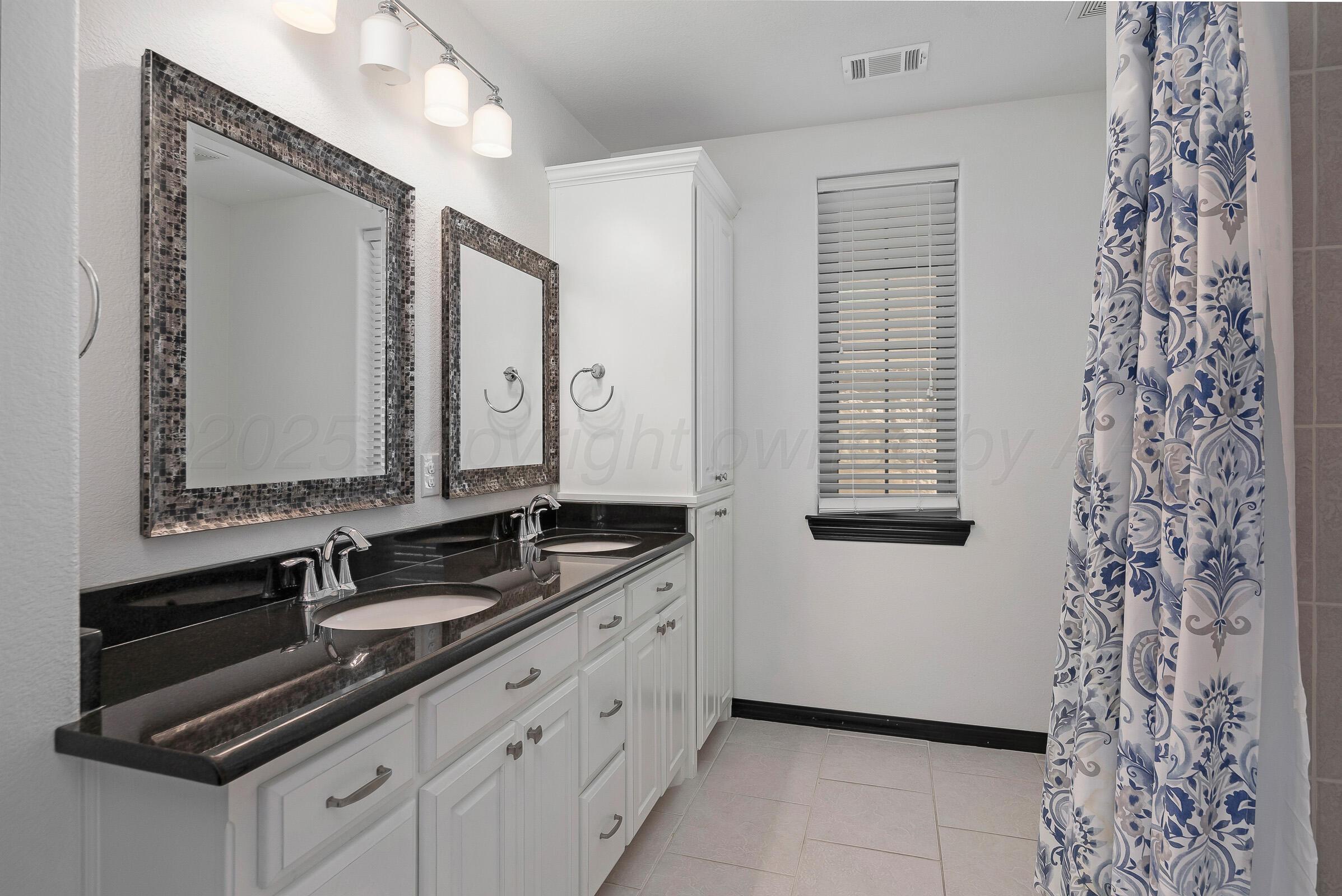 6 Merion Place Amarillo, TX 79124 - Photo 27 of 46 a bathroom with a double vanity sink and a mirror