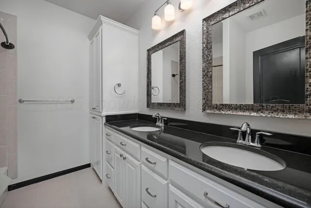 a view of a white house next to a yard