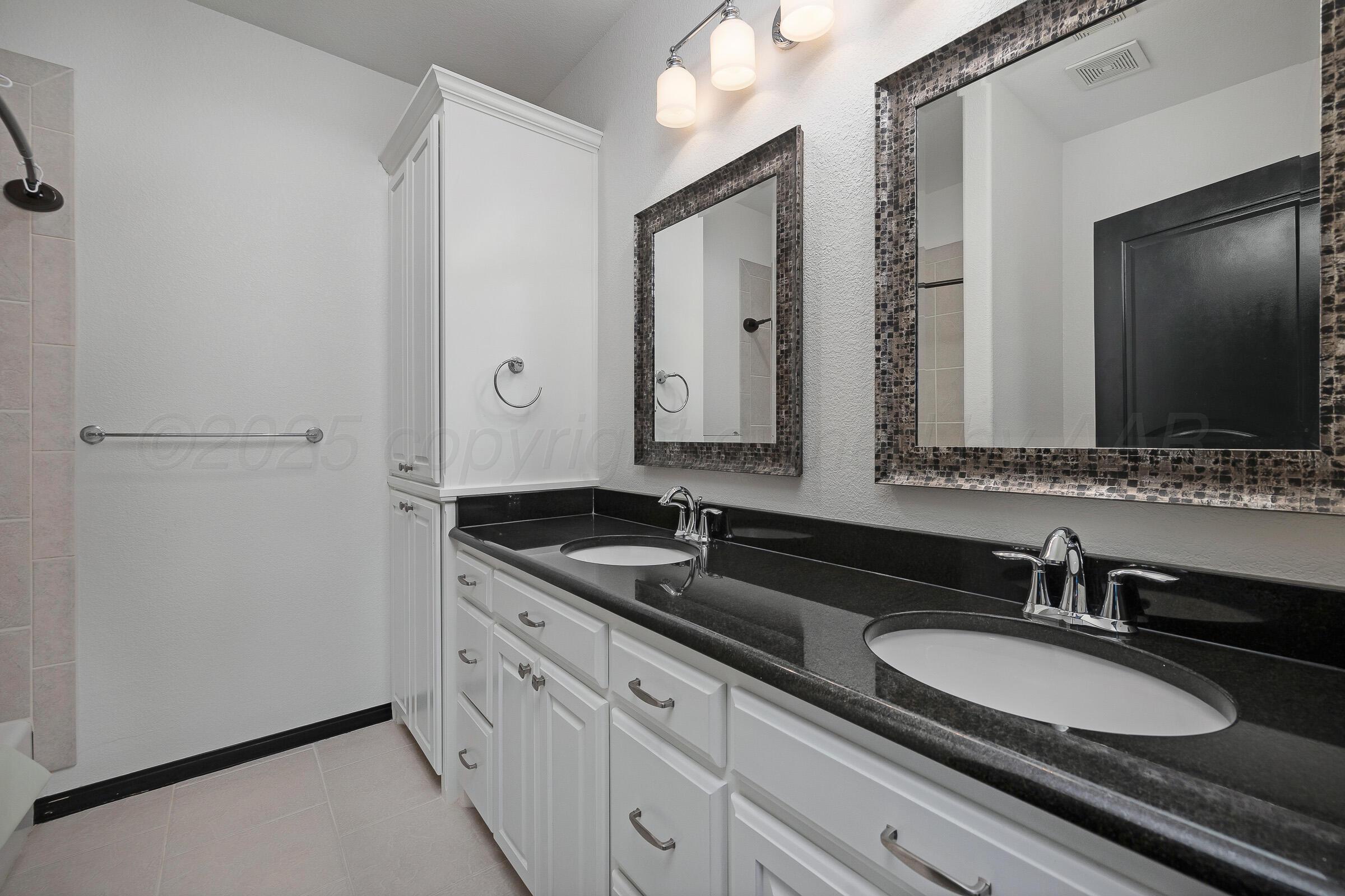 6 Merion Place Amarillo, TX 79124 - Photo 36 of 46 a bathroom with a granite countertop sink and a mirror