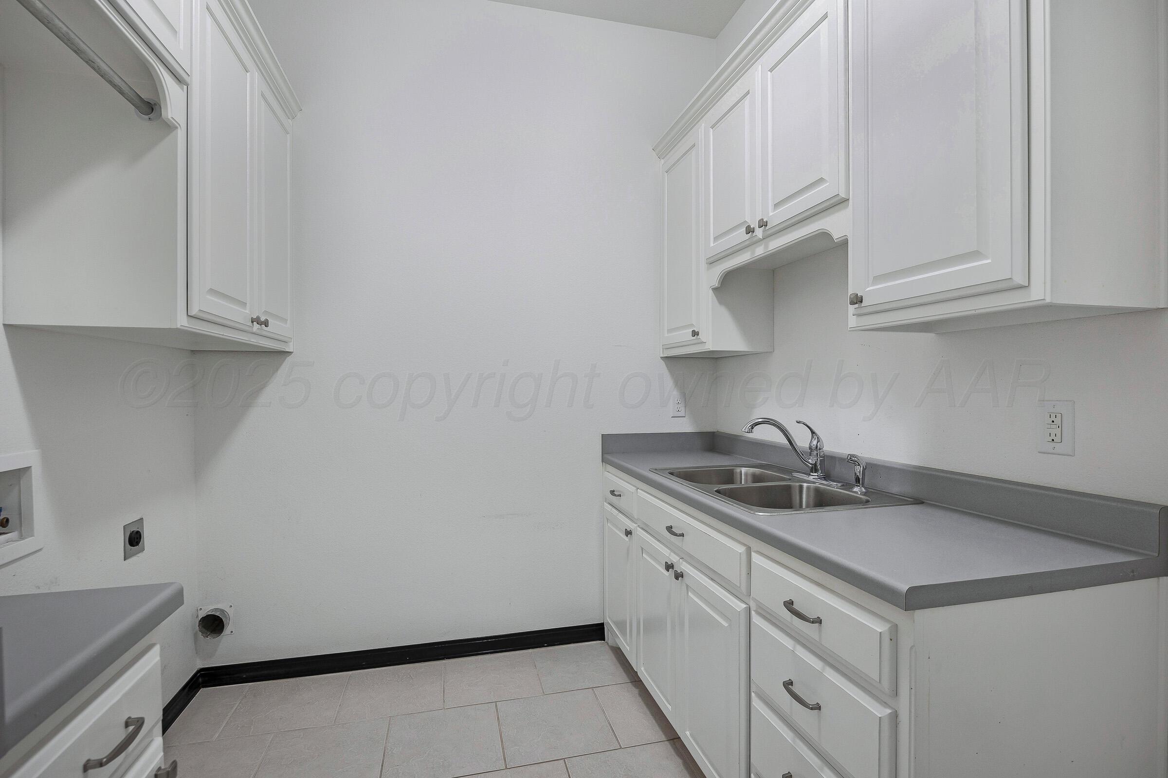 6 Merion Place Amarillo, TX 79124 - Photo 37 of 46 a kitchen with white cabinets sink and stove