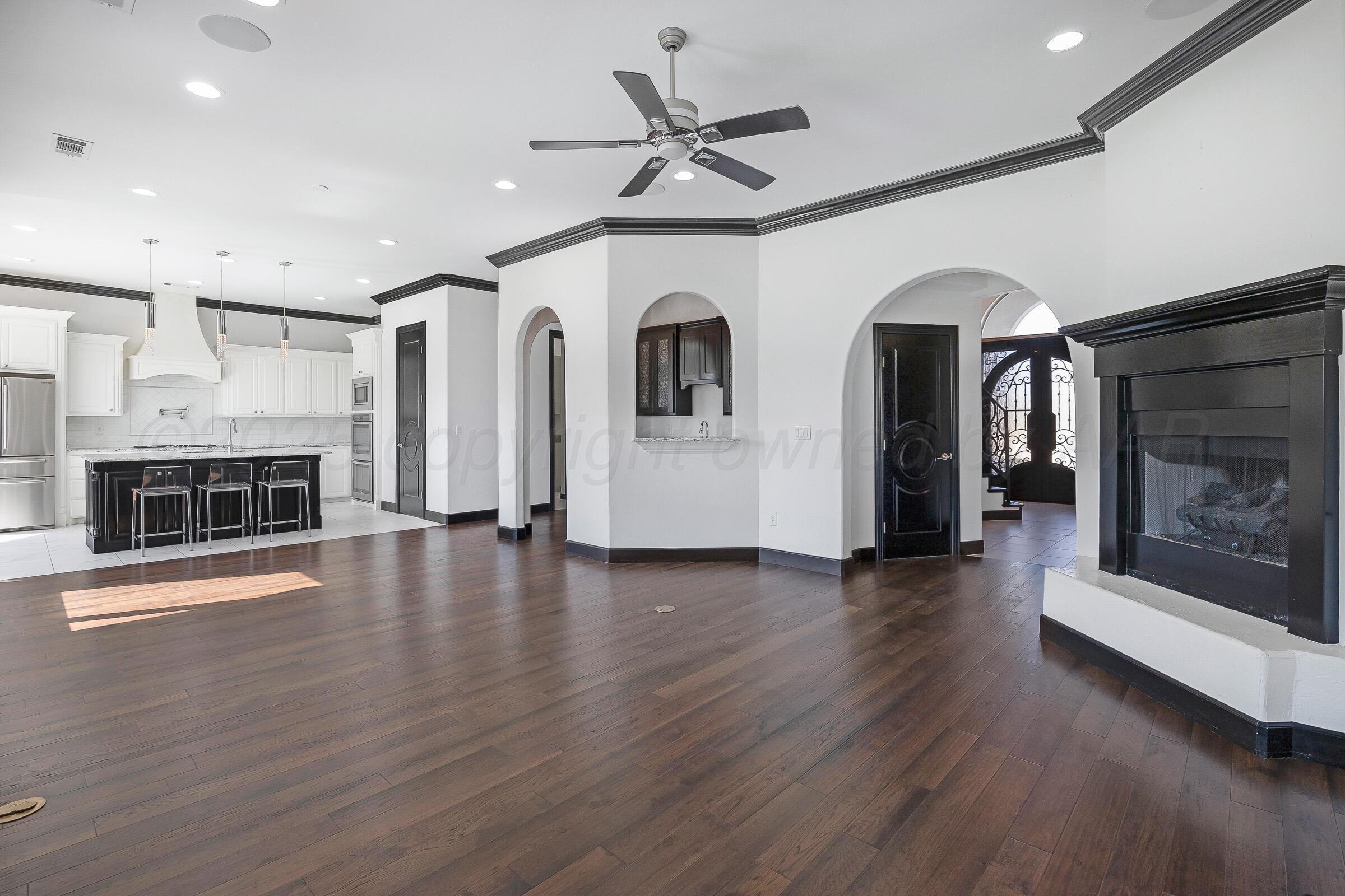6 Merion Place Amarillo, TX 79124 - Photo 7 of 46 a view of a livingroom with wooden floor and a fireplace
