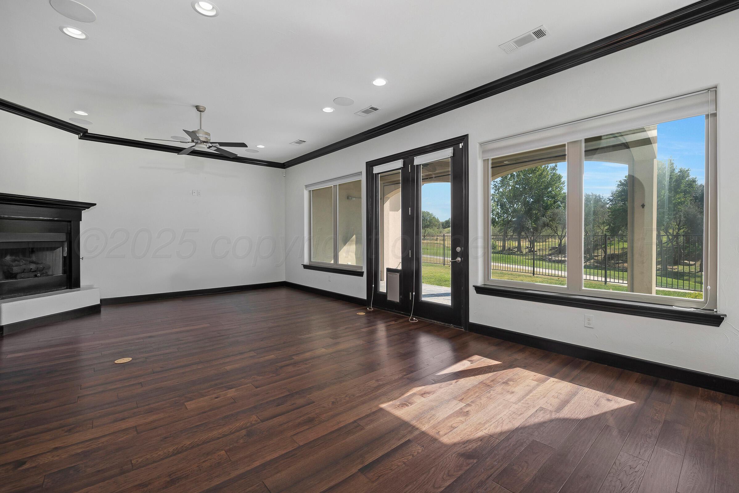 6 Merion Place Amarillo, TX 79124 - Photo 10 of 46 a view of an empty room with wooden floor and a window