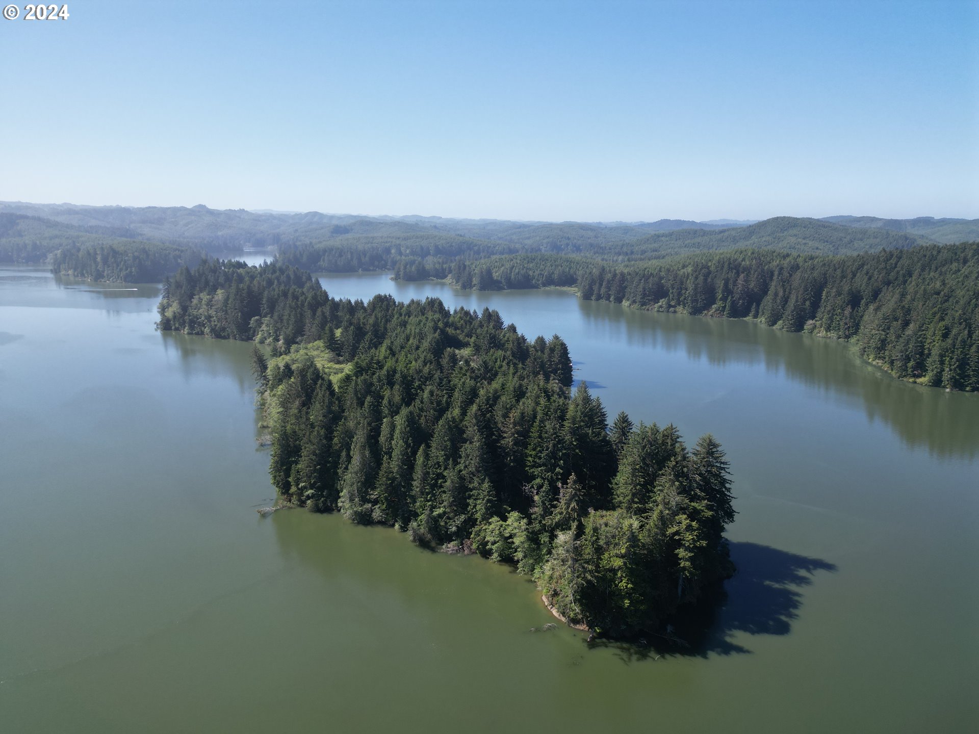 Booth Island Westlake, OR 97493 - Photo 2 of 11 a view of a lake with a mountain in the background