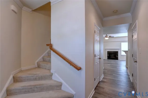 a view of a hallway with wooden floor and staircase