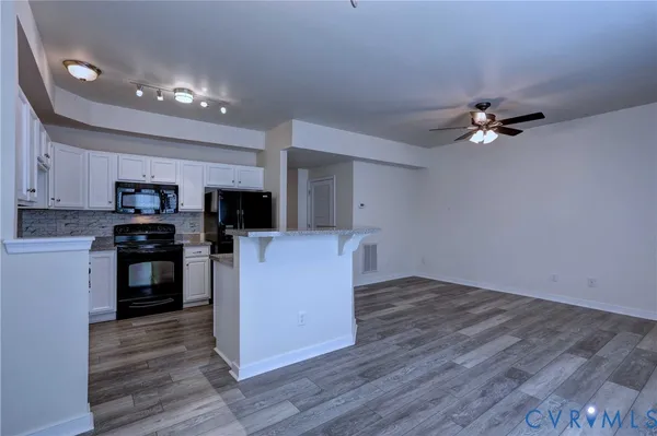 a kitchen with kitchen island microwave and stove