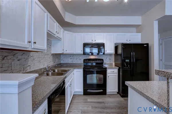 a kitchen with a sink stove and refrigerator