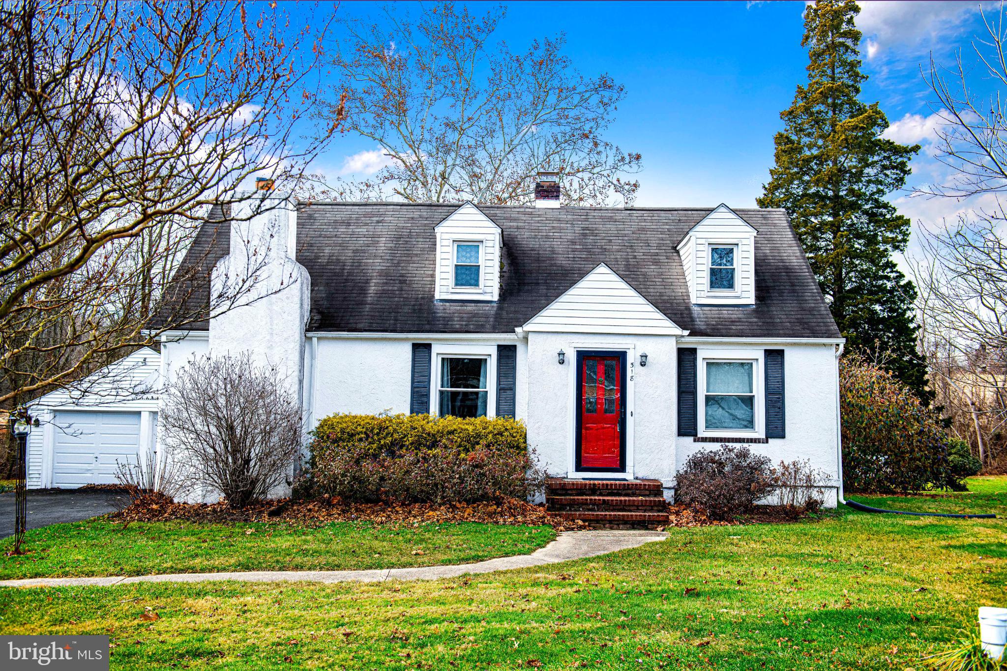 Charming home with vibrant red door.