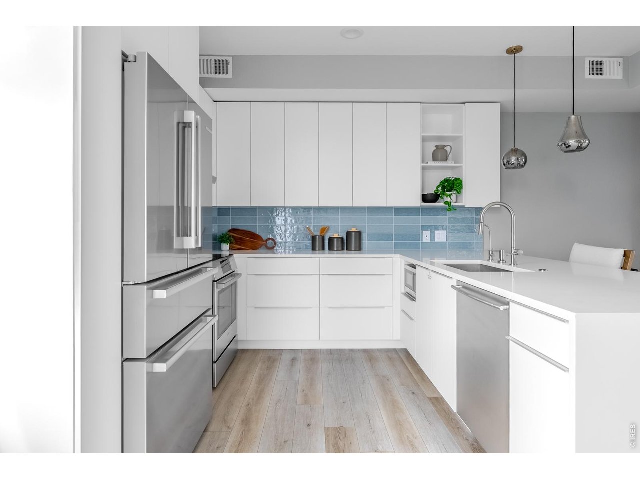 A new, Vonmod designed kitchen brings a noticeable step above typical production finishes and a feature that stands out within the community. At the stainless single-bowl sink, reverse osmosis water filtration adds a refined touch of convenience.